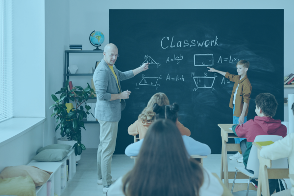 educator teaching math on chalkboard